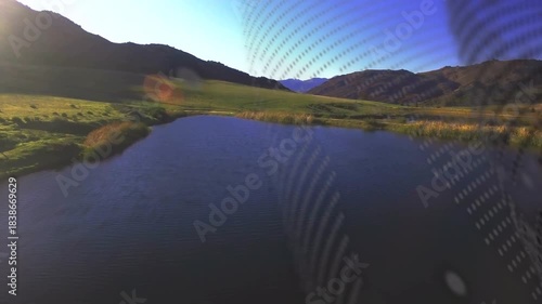 Drone moving forward starting dot grid sweeping left, pond staying centered showing lens debris