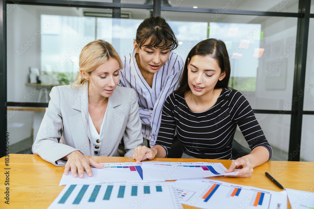 Fototapeta premium Business team analyzing data and marketing strategy in modern office, brainstorming ideas for project success using laptops and charts, teamwork collaboration for corporate growth