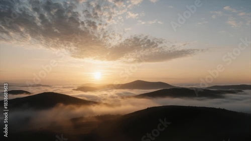 Wallpaper Mural A sunrise over mountain peaks, with fog filling valleys and cloud formations above Torontodigital.ca