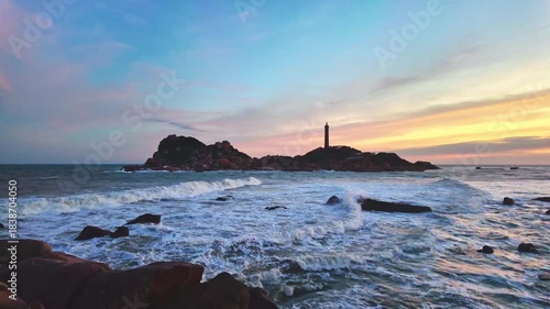 Beautiful Sunset Ke Ga Lighthouse with surf patted smoother reefs create clouds on sea as this is only ancient lighthouse is located on island in Vietnam