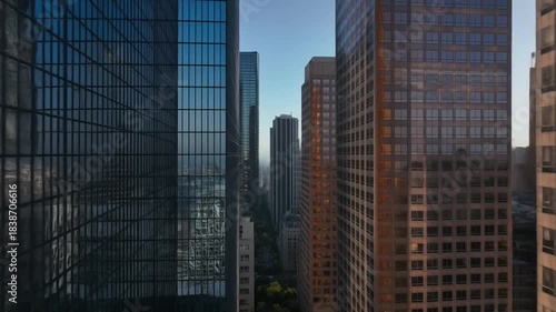 Modern city skyline with towering glass skyscrapers reflecting the sky in a metropolitan urban landscape