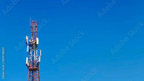 Telecommunication Cellular Tower Against Clear Bright Blue Sky Background