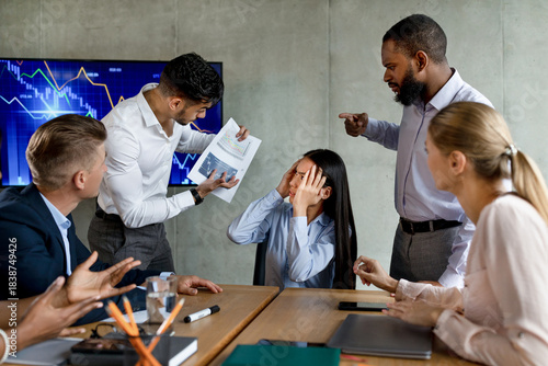 Принти на полотні In a modern office meeting, a multiethnic team argues over a failed project
