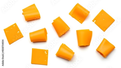 Cheddar cheese slices cut into squares and cubes isolated on white background for food concepts