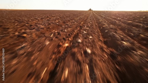 Tractor Driving Across Plowed Field, Performing Agricultural Tasks