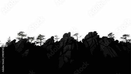 Silhouette of rugged rock formations and pine trees against a bright sky.