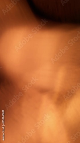 Vertical video. Blur leak. Bokeh light. Colorful beam circles glowing on dark background. Sun ray overlay abstract refraction optical effect.