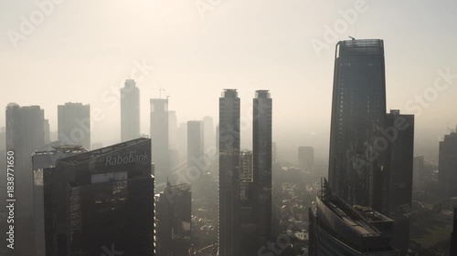 Jakarta Skyline in Haze: Aerial View of Modern Business District and Skyscrapers in Golden Morning Light