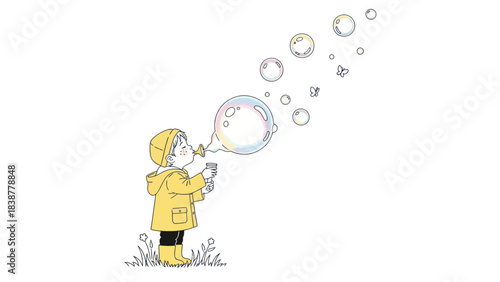 A child in a yellow raincoat blows bubbles in a grassy field.