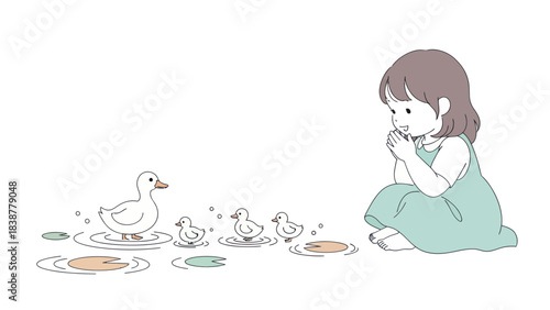 A little girl observes a duck family with ducklings in a pond.