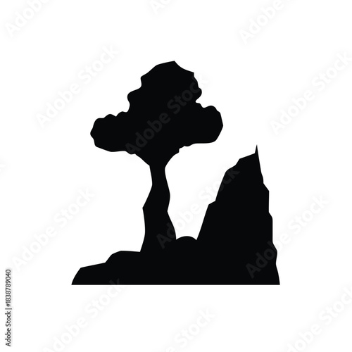 Black silhouette of a tree and rock cliff