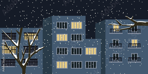 Snowy Night in the City Apartments with Warm Lit Windows. Hotel building exterior. Winter building . Heavy snow.