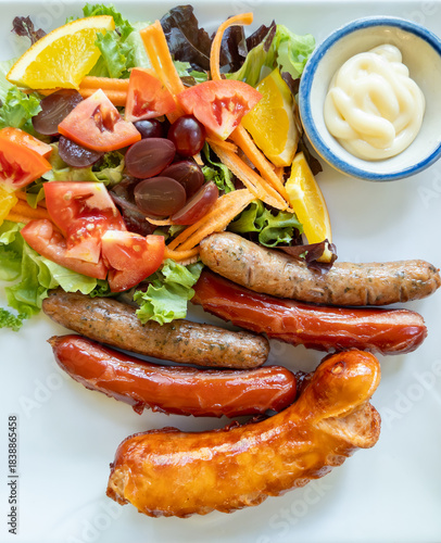Grilled Mixed Sausages with Fresh Salad and Fruits.