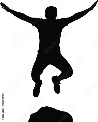 Silhouette of a man jumping high with arms spread in celebration