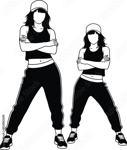 Silhouette of two women striking a hip hop dance pose