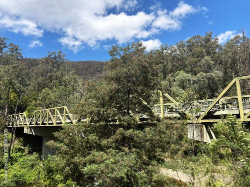 Mountain forest bridge and weather clouds during the Summer