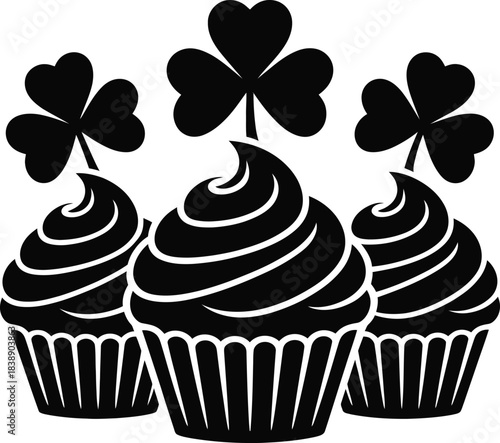 Three black and white cupcakes with shamrock toppers