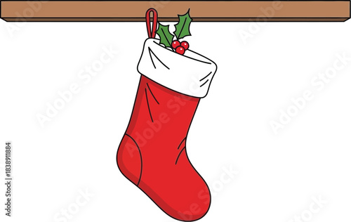 Bright red christmas stocking with white cuff and holly berries hangs from a wooden mantelpiece
