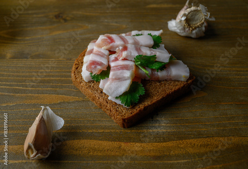Hearty Black Bread and Salo on Aged Wooden Table