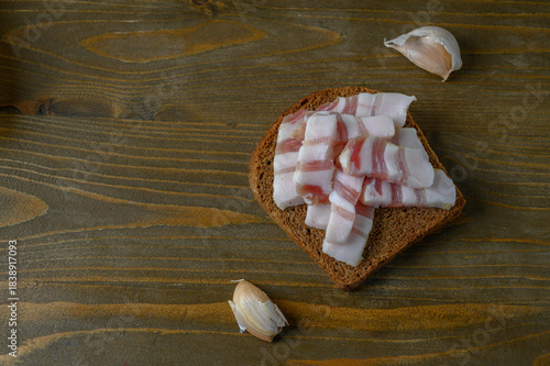 Simple Dark Bread and Salo on Rough Wooden Plank