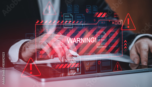 Cybersecurity warning concept with digital alert symbols and documents over tablet on corporate background in red tone, showcasing security threat detection.