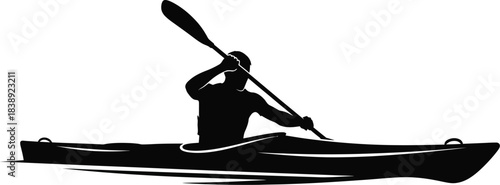 Silhouette of a kayak gliding through water while paddling