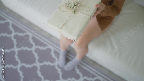 Young asian woman receiving gift box and sitting on couch in living room. Happy new year, Thanksgiving, Merry Christmas, Happy birthday