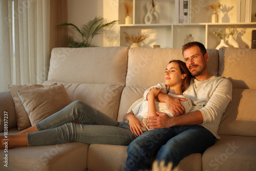 Couple in love relaxing at sunset at home