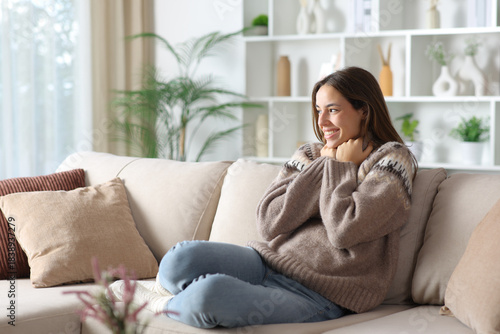 Happy woman in winter wearing jersey keeping warm