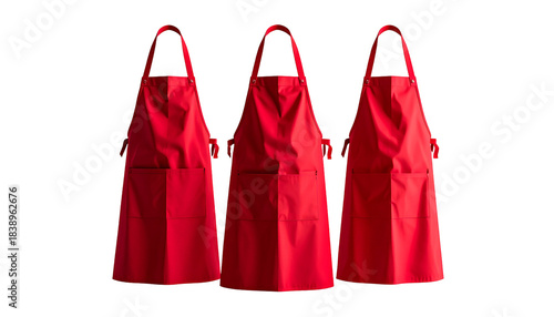 Three red aprons against a black backdrop