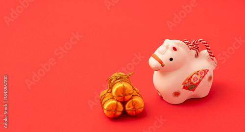 Japanese new year material. Zodiac Horse. Horse ornament on the red background. 日本のお正月素材。干支の午（ウマ）。赤背景上の午の置物	

