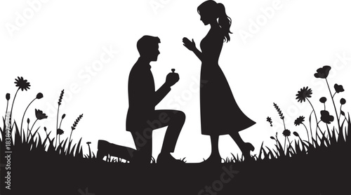 Man proposing to woman with ring in field of flowers silhouette