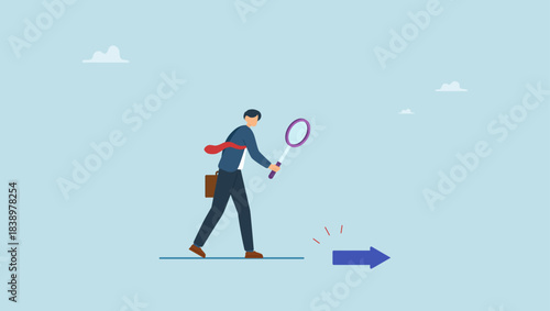 Businessman leader using magnifying glass to discover arrow on the floor. Searching for business direction, strategy or discover business opportunity or solution for work difficulty.
