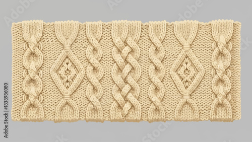 Closeup of an offwhite cable knit fabric swatch with braided patterns