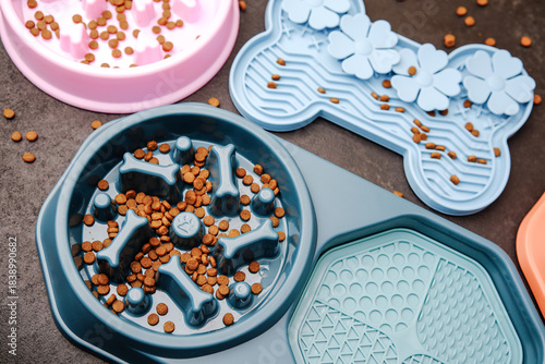 Pets slow feeder bowls with dry food on dark surface, fun pet mealtime bowls