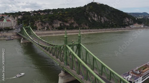 Wallpaper Mural Aerial view of the liberty Bridge with its green steel structure spanning the Danube, contrasting with the lush green Gellert Hill, Budapest, Hungary. Torontodigital.ca