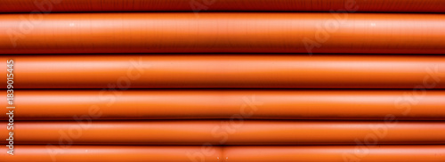 Stack of Orange pipe made of polyvinyl chloride