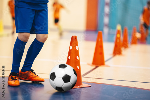 Children Playing Indoor Soccer. Youth Football Training and Drills with Cones in Sports Hall