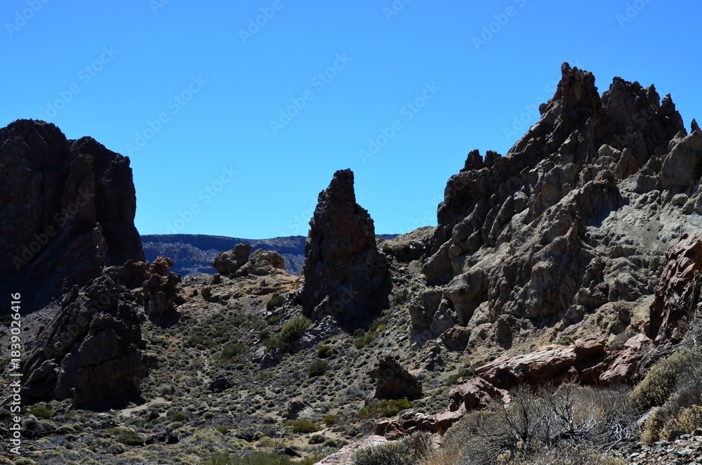 Fototapeta premium Scenic view of volcanic rock formations in desert during sunny day, Teide National Park, Tenerife