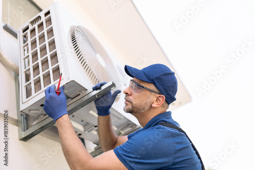 Wallpaper Mural Repairman fixing AC outdoor unit. Torontodigital.ca