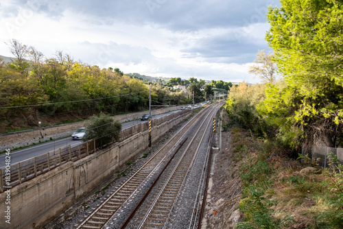 Parallel railway tracks and Strada Statale Adriatica in Pineto, Abruzzo, connecting transport and natural landscapes