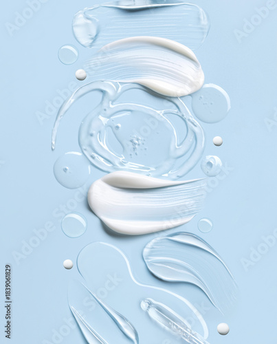 samples of cosmetic care products smear of cream and gel texture on a light blue background, moisturizing and skin care concept