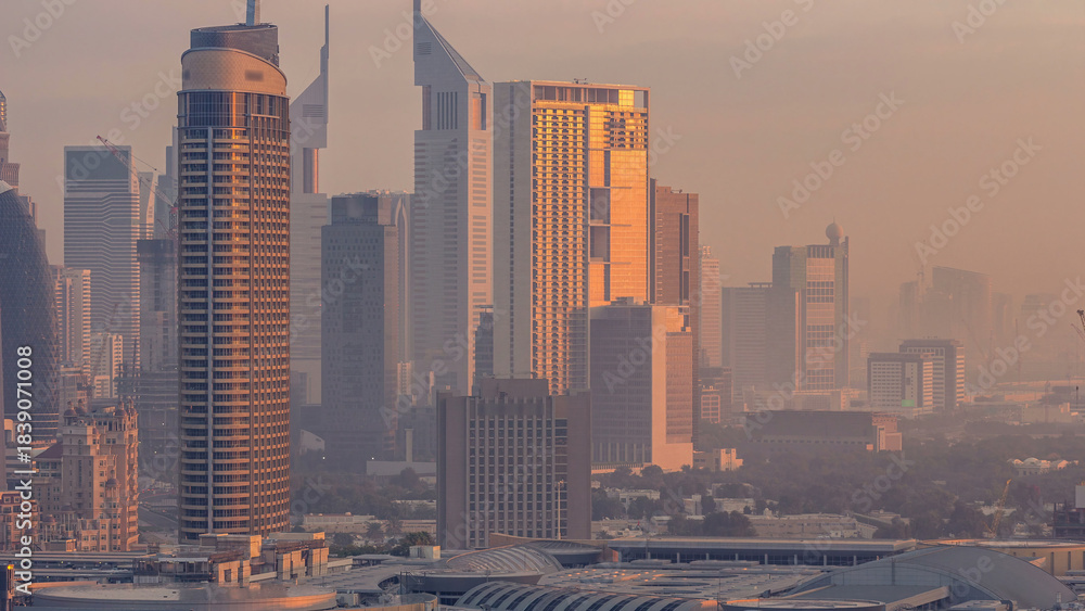 Obraz premium Dubai Downtown night to day timelapse. Aerial view over big futuristic city by night.