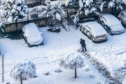 A photo from a snowy period. Trees and vehicles are covered in snow. Snow is being cleared from the ground. Türkiye, Bursa, January 19, 2022.