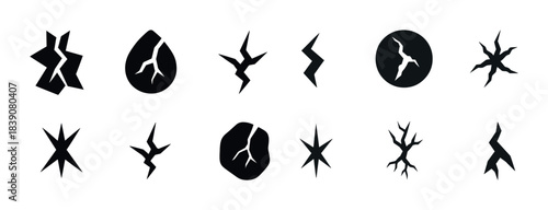 Collection of abstract crack and fracture shapes in black silhouette