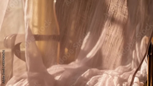 Soft Fabric Drapes Gracefully Over Antique Chair in Warm Sunlight.