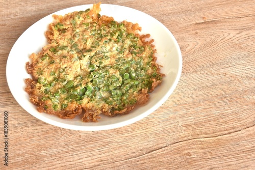 crispy fried egg omelets stuffed chop yard long bean Chinese food on dish  