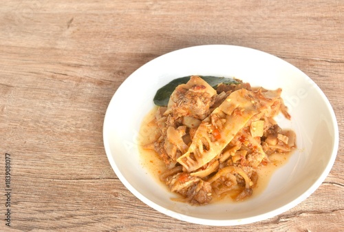 spicy fried slice pickled bamboo shoot with beef meat in curry sauce on plate