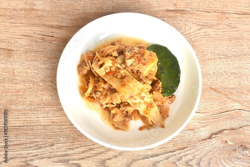 spicy fried slice pickled bamboo shoot with beef meat in curry sauce on plate