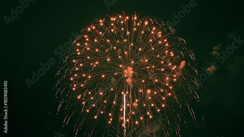 Spectacular Red Fireworks Display Illuminating the Night Sky.